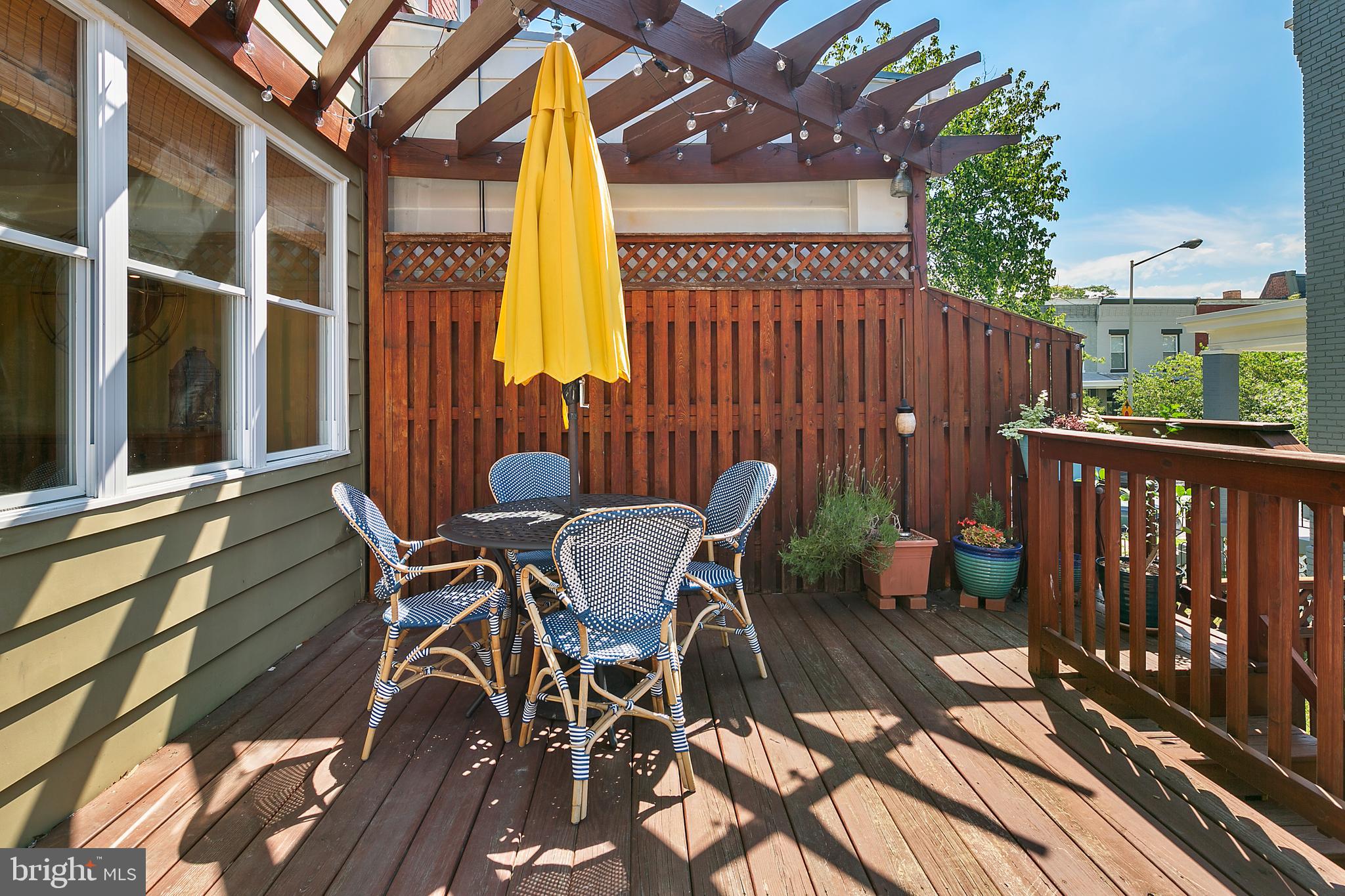925 K Street Northeast Washington, DC 20002 - Photo 16 of 35 a view of a patio with table and chairs with wooden floor and fence