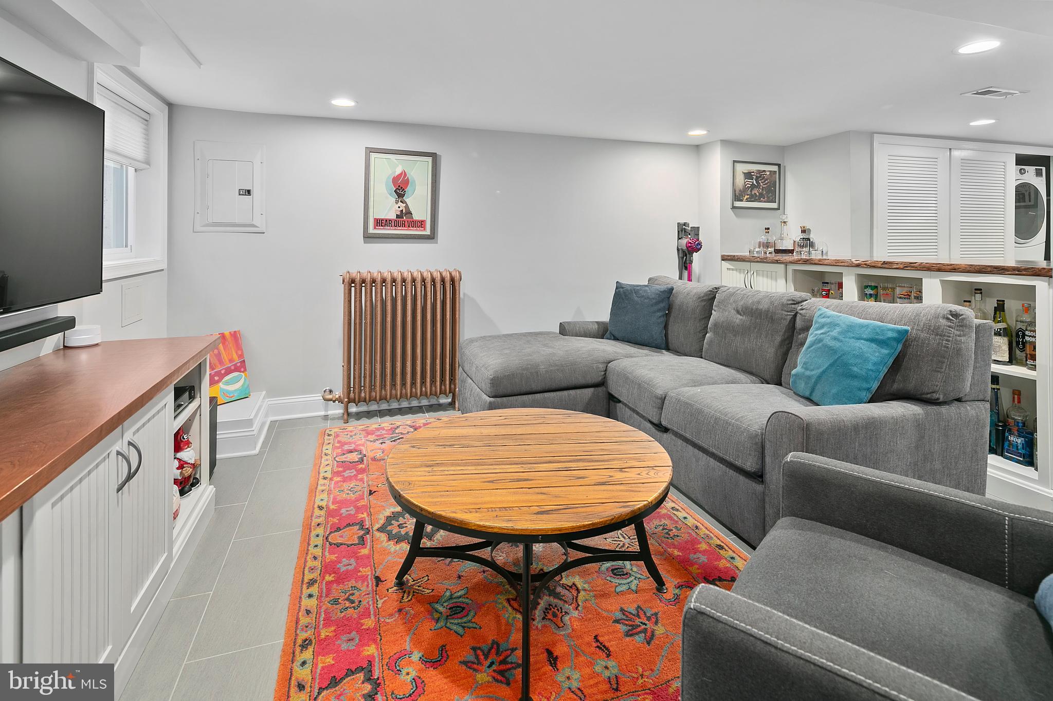 925 K Street Northeast Washington, DC 20002 - Photo 26 of 35 a living room with furniture and a flat screen tv