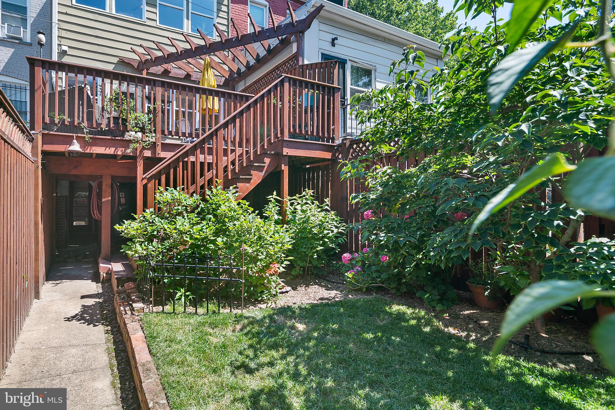 925 K Street Northeast Washington, DC 20002 - Photo 32 of 35 a view of a house with brick walls and flower plants in front of main door