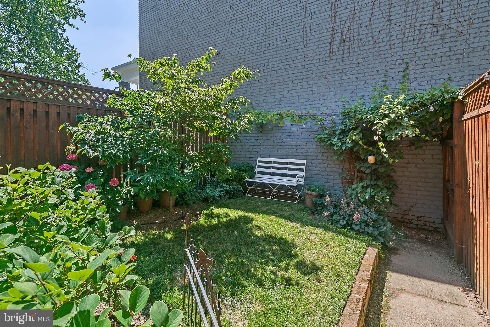 925 K Street Northeast Washington, DC 20002 - Photo 33 of 35 a garden with plants and wooden fence