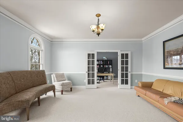 a living room with furniture and large windows