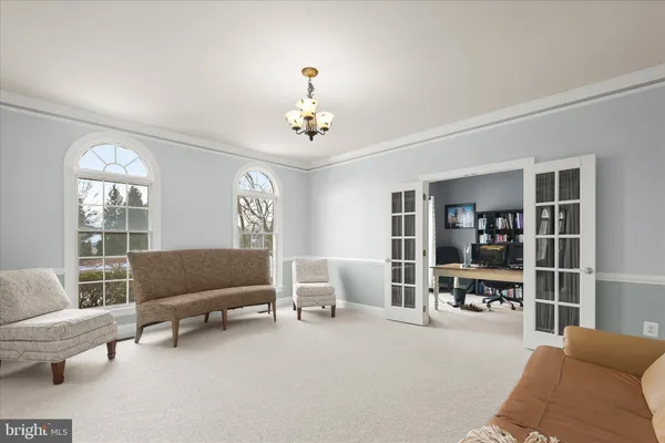 a living room with furniture a fireplace and a large window