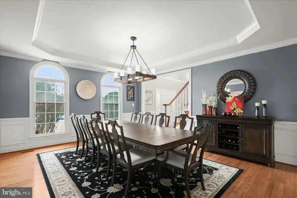 a view of a dining room with furniture wooden floor and chandelier