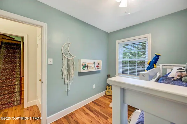 a view of a bedroom with table and workspace
