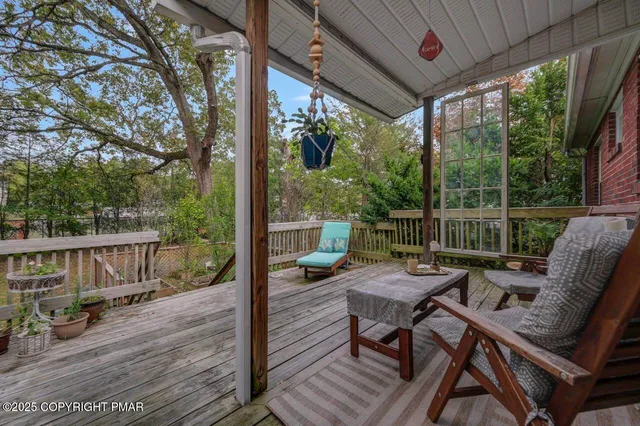 a view of a chair and tables in the balcony