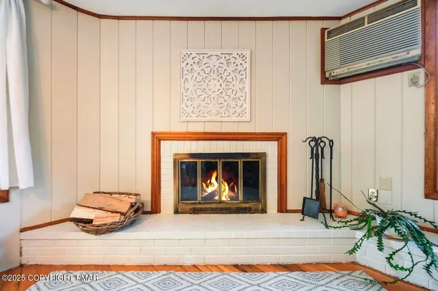 a dining room with furniture potted plants and wooden floor