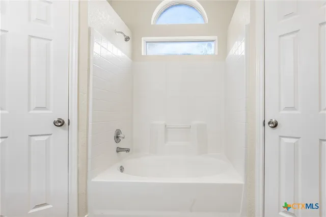 a bathroom with bathtub and shower
