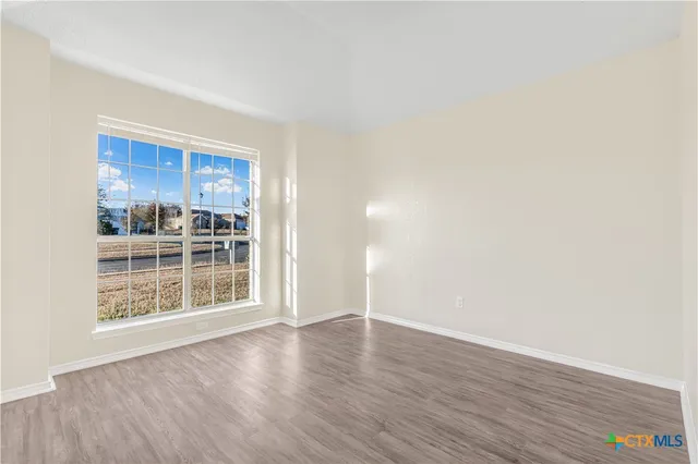 a view of wooden floor and windows in a room