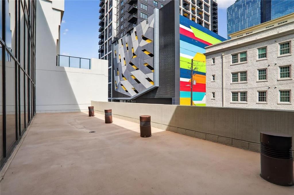 1280 West Peachtree Street Northwest, Unit 3014 Atlanta, GA 30309 - Photo 22 of 33 a close view of an empty room with wooden floor and windows
