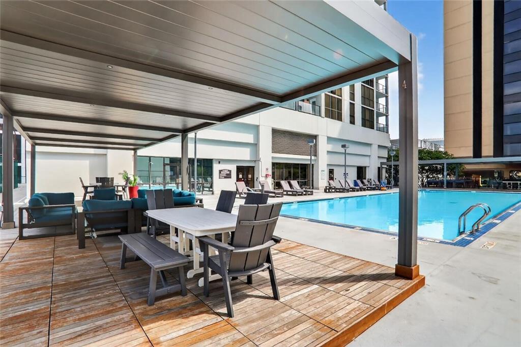 1280 West Peachtree Street Northwest, Unit 3014 Atlanta, GA 30309 - Photo 26 of 33 a view of a patio with table and chairs floor to ceiling window with wooden floor