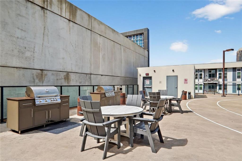 1280 West Peachtree Street Northwest, Unit 3014 Atlanta, GA 30309 - Photo 27 of 33 a dinning table and chairs in a patio