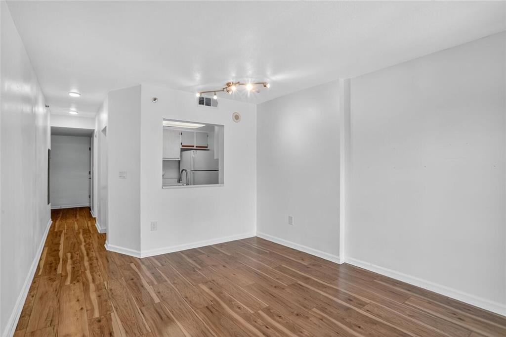 1280 West Peachtree Street Northwest, Unit 3014 Atlanta, GA 30309 - Photo 4 of 33 a view of empty room with wooden floor and fan
