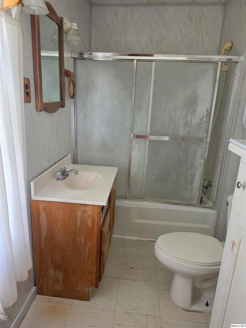 304 West 3rd Street Golden, IL 62339 - Photo 8 of 18 a bathroom with a sink toilet and shower