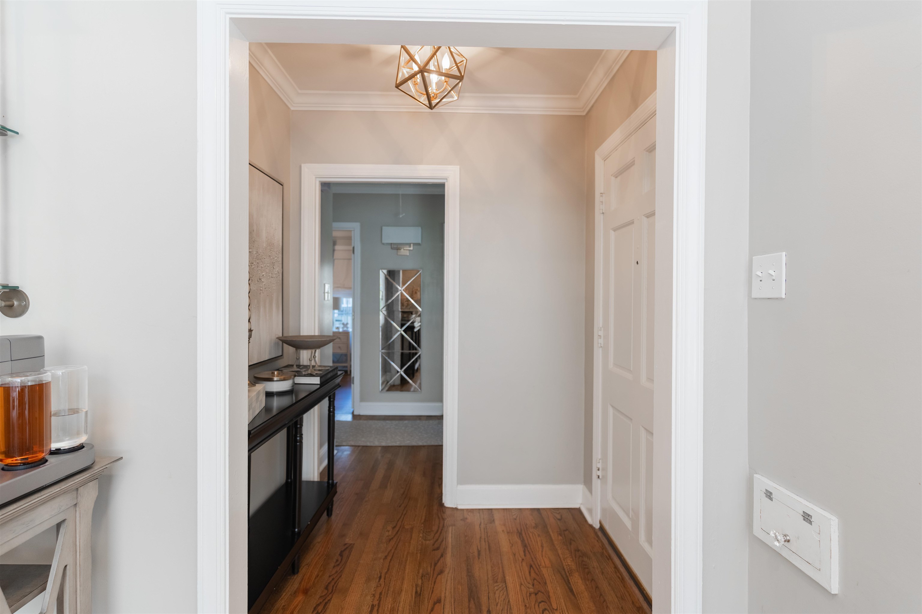 497 East Swan Ridge Circle Memphis, TN 38122 - Photo 11 of 29 Corridor with a chandelier, dark hardwood / wood-style floors, and ornamental molding