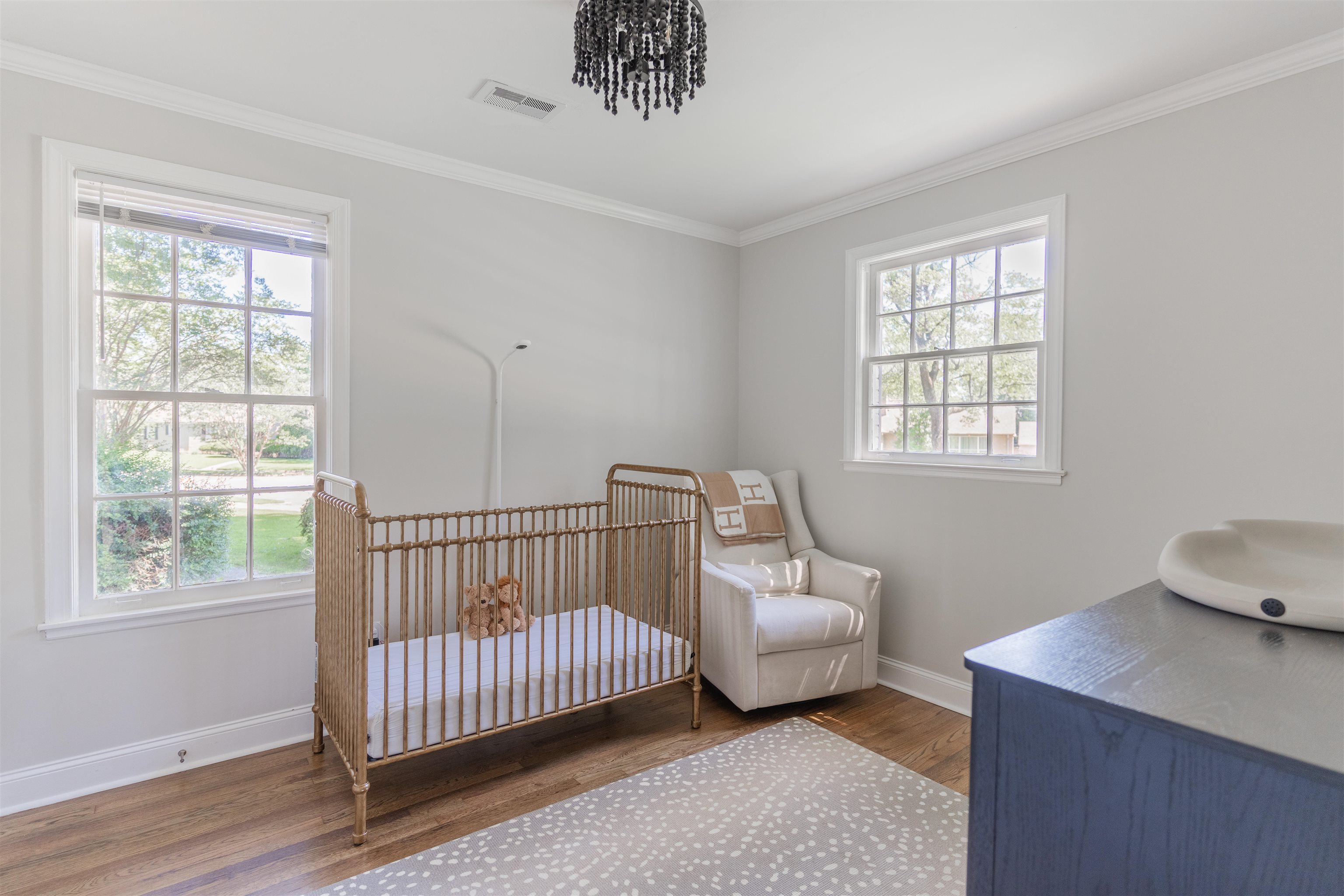 497 East Swan Ridge Circle Memphis, TN 38122 - Photo 14 of 29 Bedroom featuring an inviting chandelier, wood-type flooring, a crib, and ornamental molding