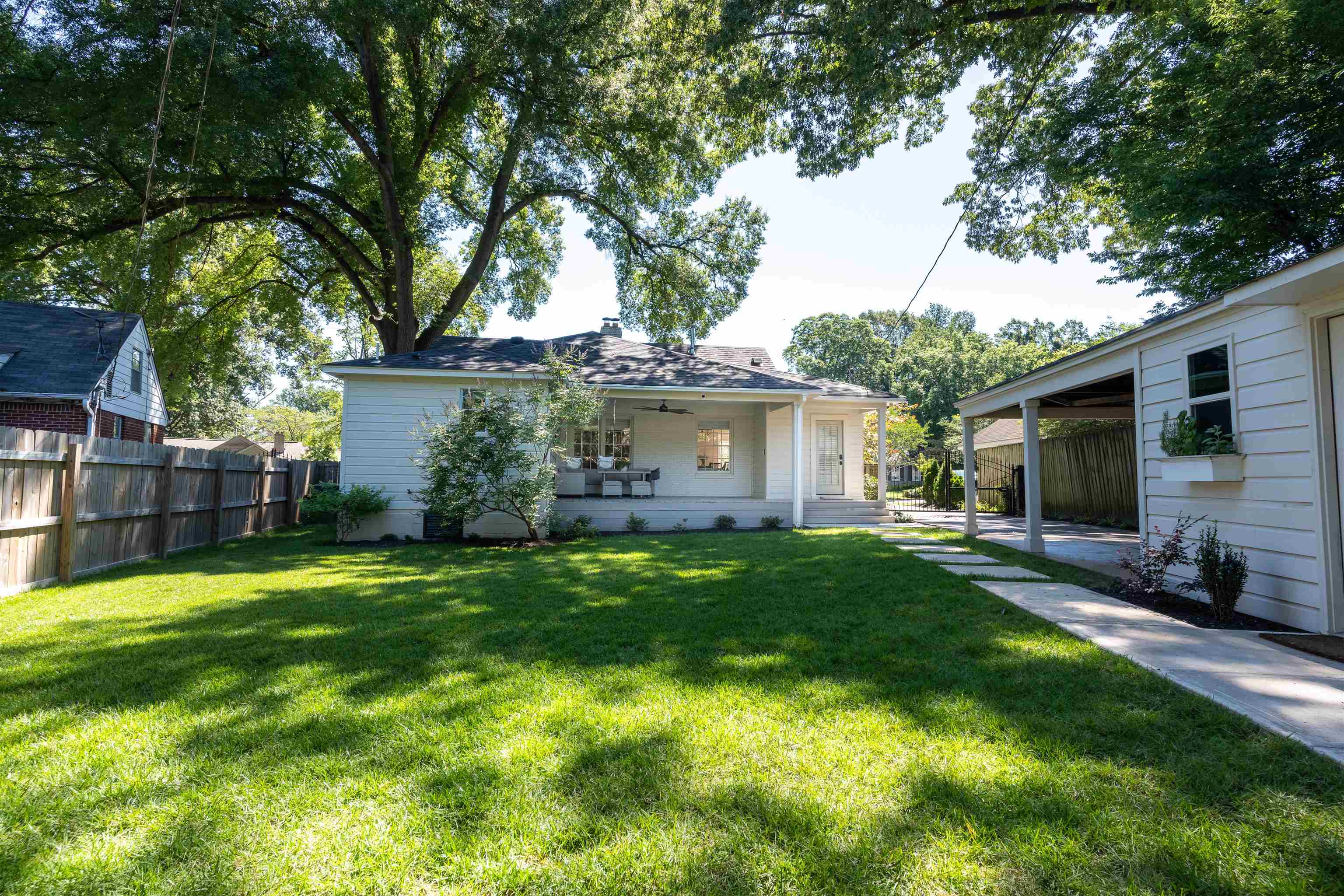 497 East Swan Ridge Circle Memphis, TN 38122 - Photo 28 of 29 Back of property featuring a lawn, a carport, and covered porch