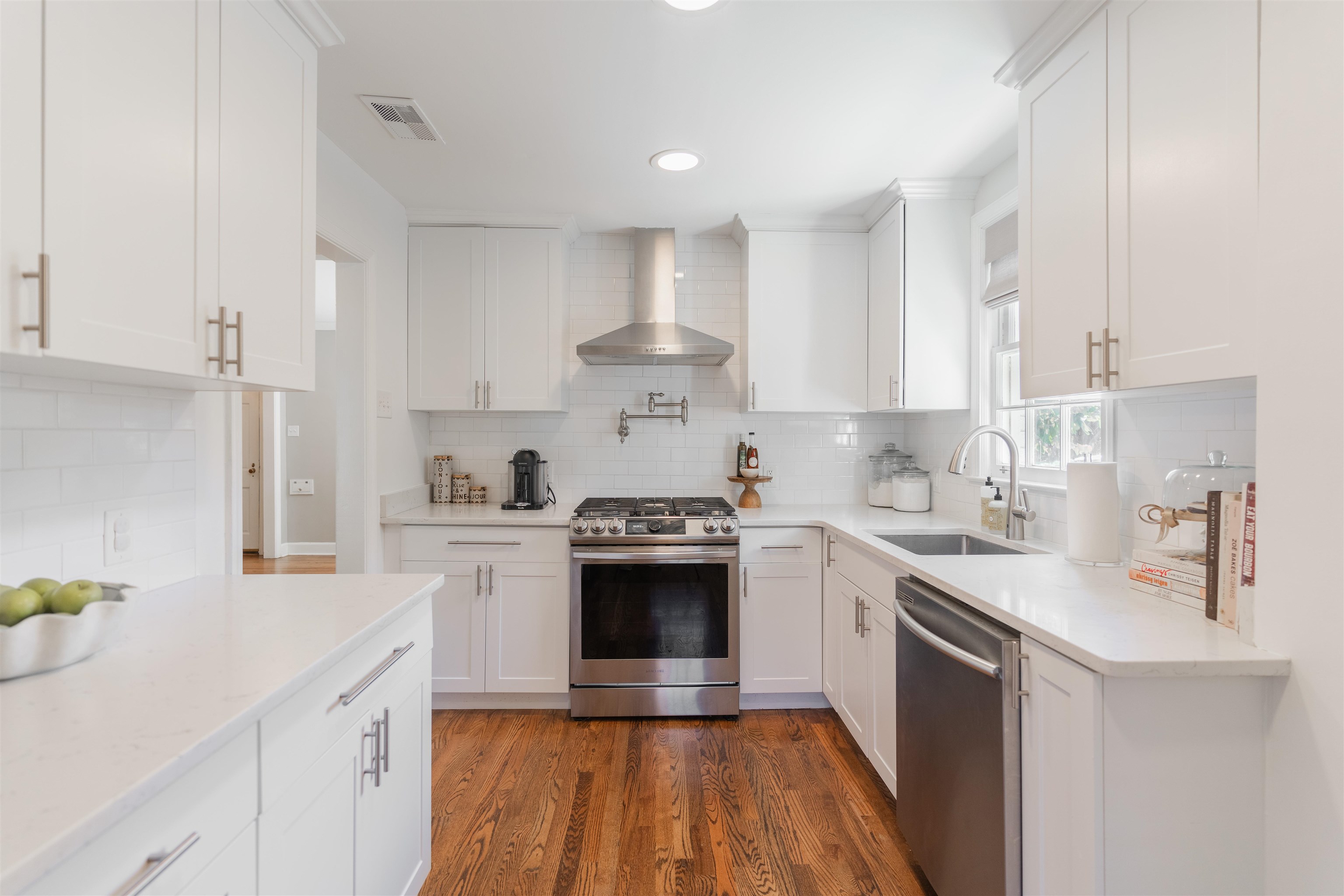 497 East Swan Ridge Circle Memphis, TN 38122 - Photo 9 of 29 Kitchen featuring white cabinetry, sink, wall chimney exhaust hood, and stainless steel appliances