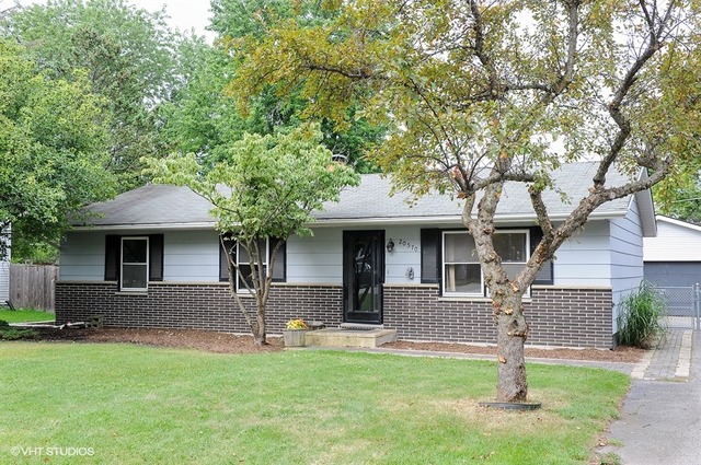 20570 North Clarice Avenue Prairie View, IL 60089 - Photo 1 of 10 a front view of a house with a garden and trees
