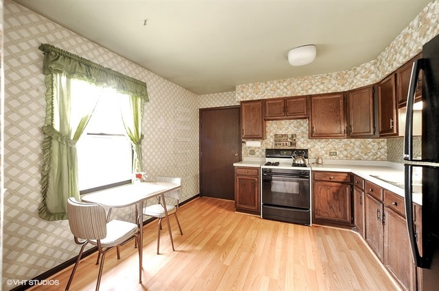 20570 North Clarice Avenue Prairie View, IL 60089 - Photo 4 of 10 a kitchen with stainless steel appliances granite countertop a stove a sink dishwasher and a refrigerator with wooden cabinets