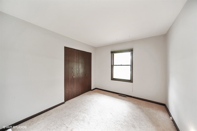 20570 North Clarice Avenue Prairie View, IL 60089 - Photo 6 of 10 an empty room with windows and closet