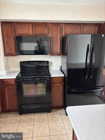 a kitchen with granite countertop a refrigerator and a stove