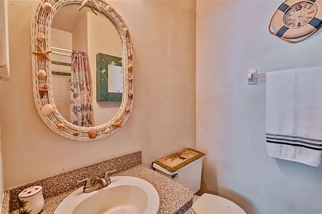 a bathroom with a toilet mirror and tub