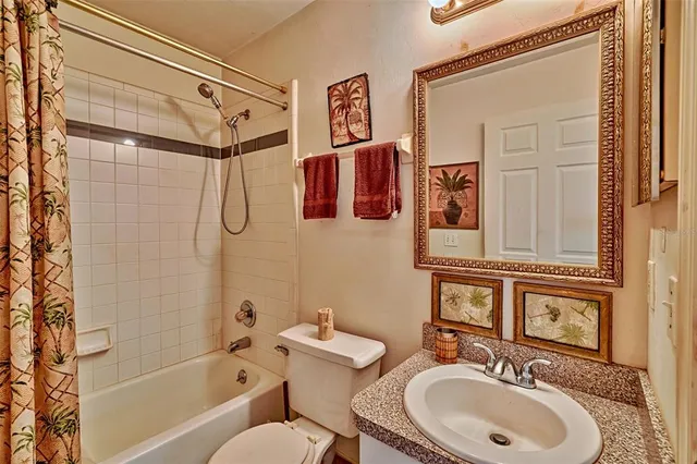 a bathroom with a sink toilet mirror and shower