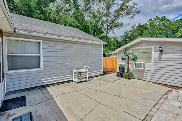 a view of house with backyard and sitting area