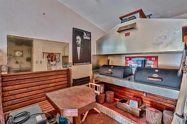 a living room with furniture pool table and chairs