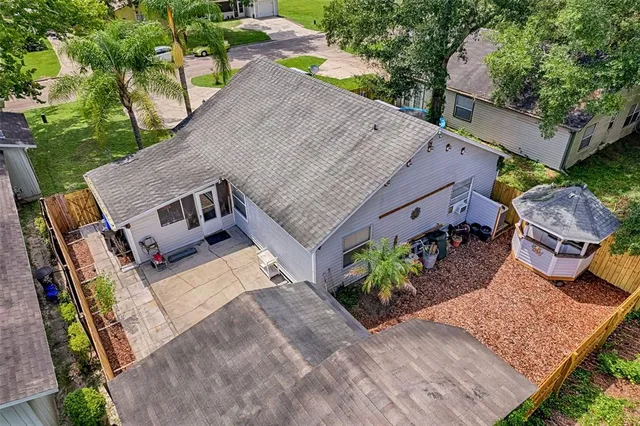 an aerial view of a house with garden space and sitting area