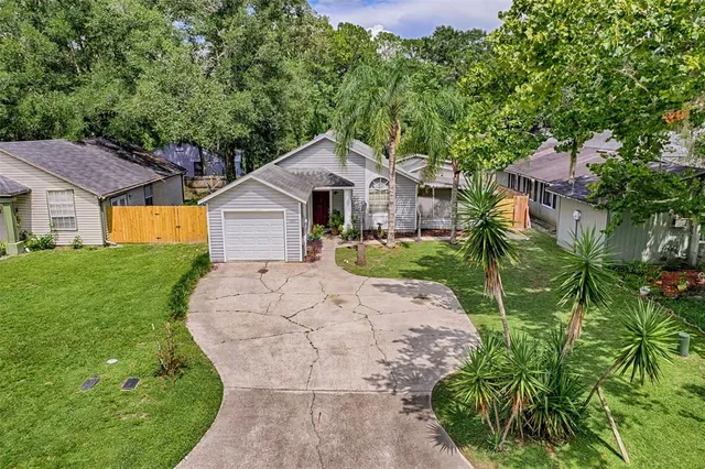 a front view of a house with a yard and trees