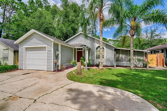 a front view of a house with a garden and patio