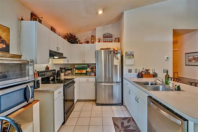 a kitchen that has a refrigerator and a sink