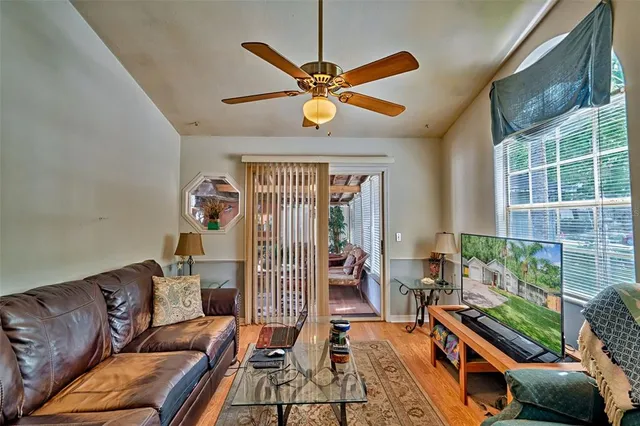 a living room with furniture a fireplace and a window