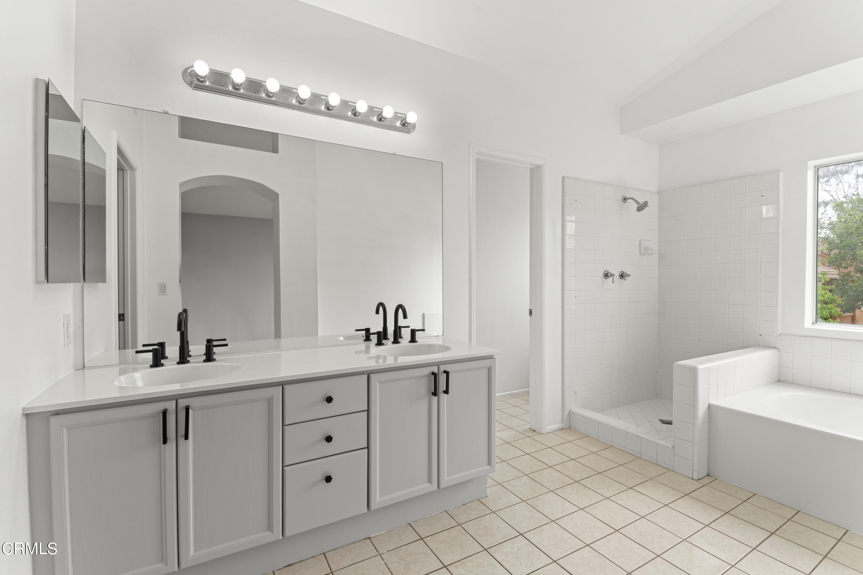 738 Moby Dick Lane Oxnard, CA 93030 - Photo 25 of 48 a en suite bathroom with a double vanity sink a mirror and a bathtub