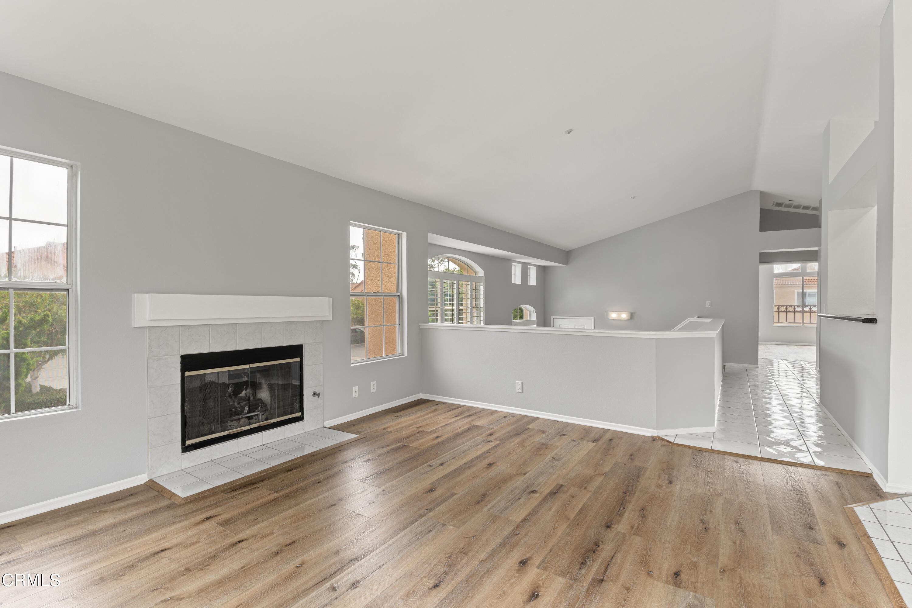738 Moby Dick Lane Oxnard, CA 93030 - Photo 27 of 48 a view of an empty room with wooden floor fireplace and a window