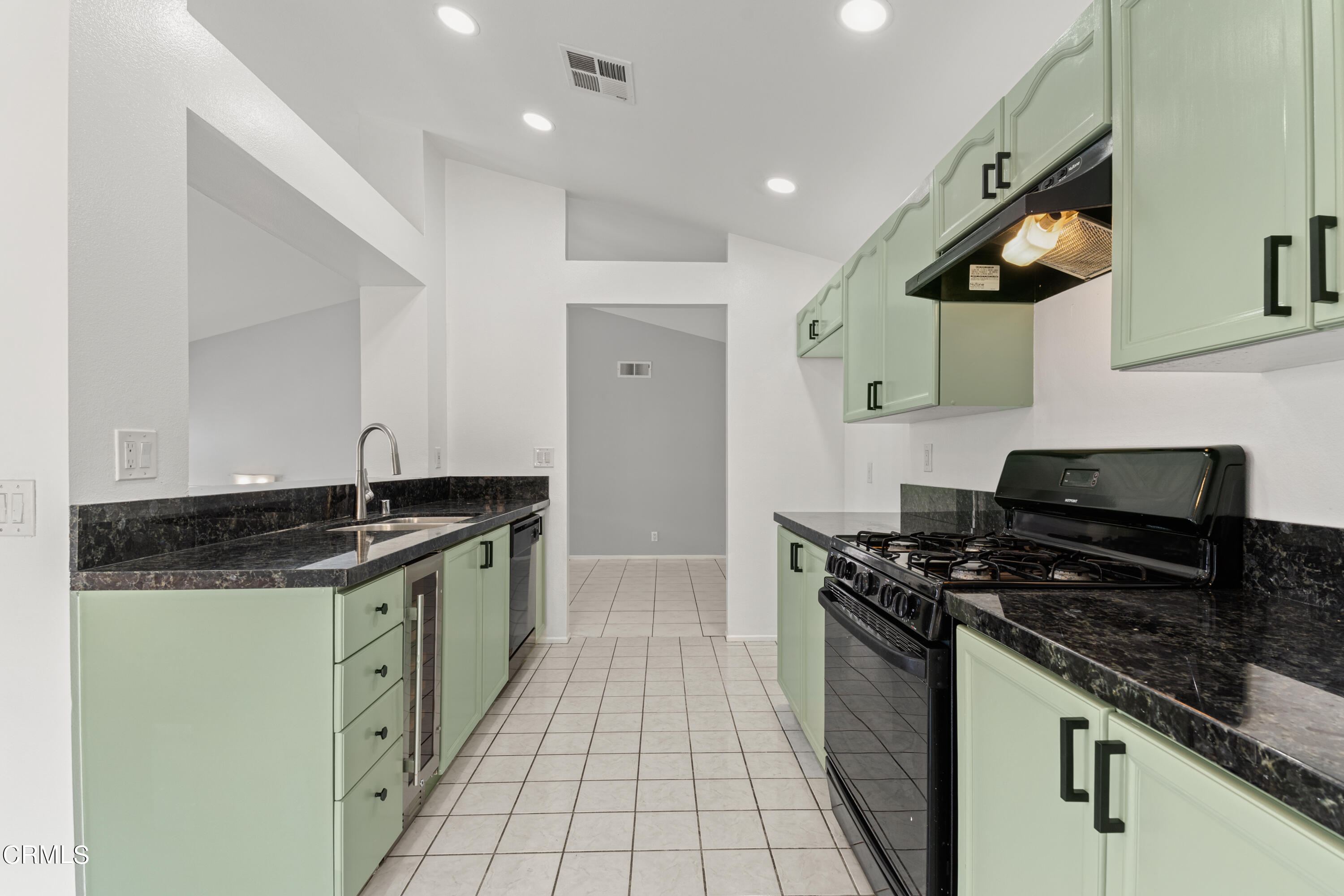 738 Moby Dick Lane Oxnard, CA 93030 - Photo 34 of 48 a kitchen with stainless steel appliances granite countertop a stove a sink and a microwave