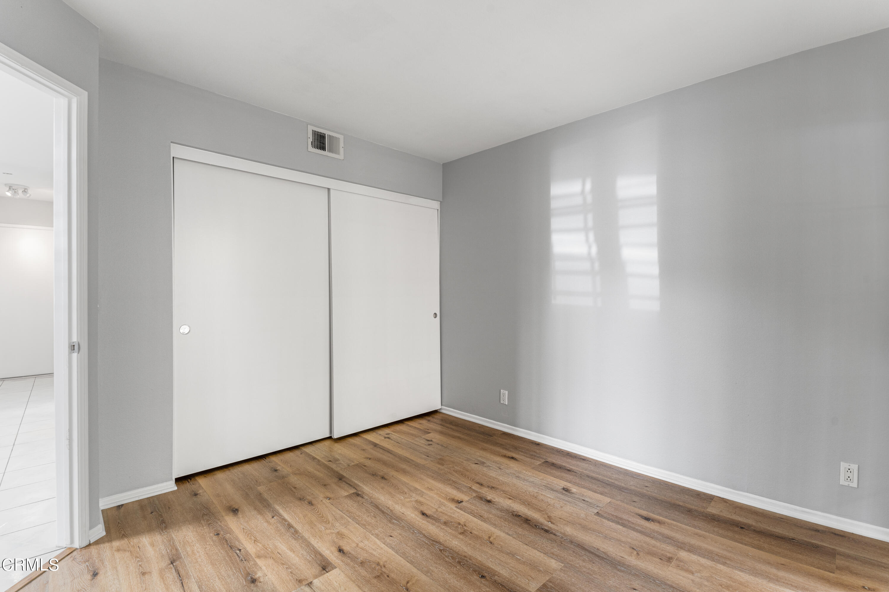 738 Moby Dick Lane Oxnard, CA 93030 - Photo 44 of 48 a view of an empty room with wooden floor