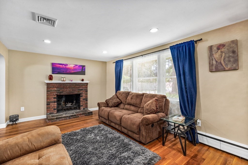 17 Pinetree Road Stoughton, MA 02072 - Photo 12 of 34 a living room with furniture and a fireplace