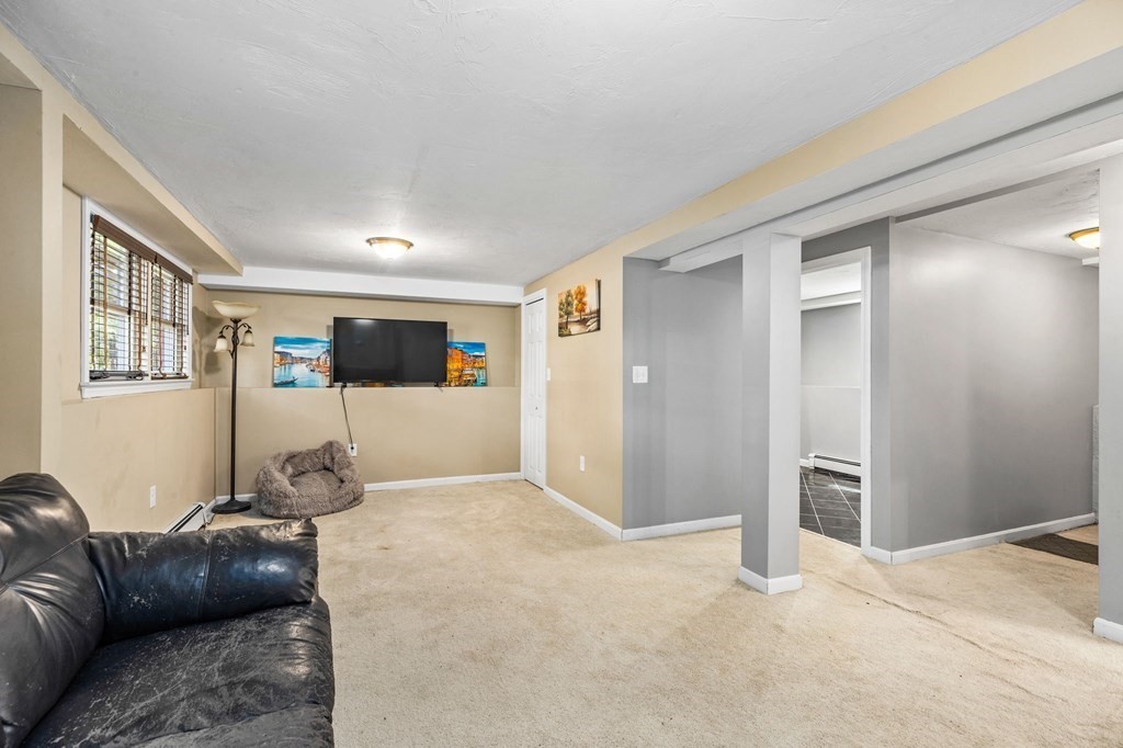 17 Pinetree Road Stoughton, MA 02072 - Photo 21 of 34 a living room with a couch and a refrigerator