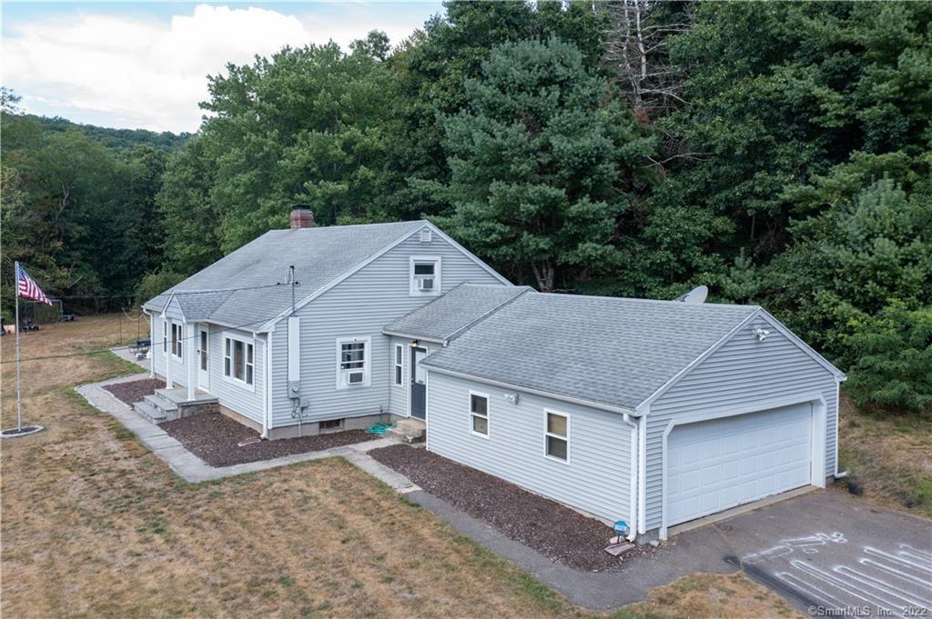 44 Old River Road Willington, CT 06279 - Photo 1 of 1 an aerial view of a house with a yard balcony and mountain view in back