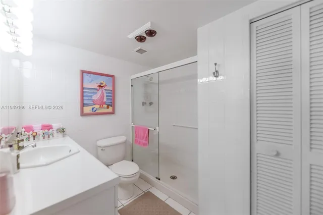 a bathroom with a sink vanity mirror and tub