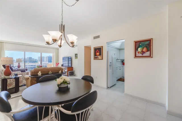 a view of a dining room with furniture and a chandelier