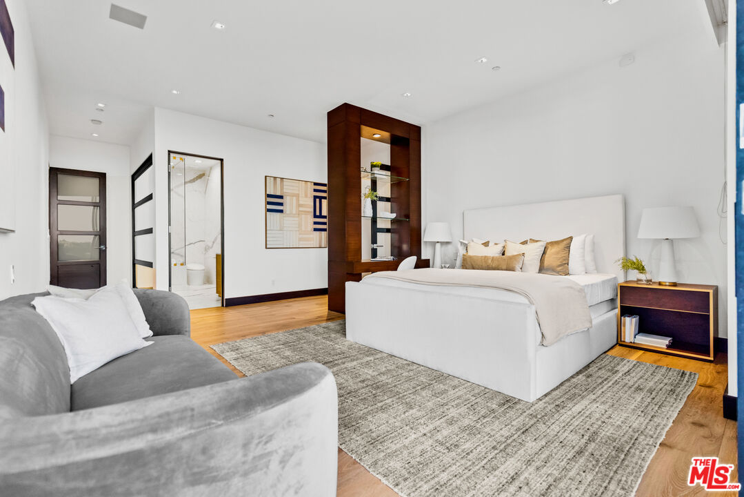 9374 Beverlycrest Drive Beverly Hills, CA 90210 - Photo 12 of 24 a bedroom with a large bed and a couch