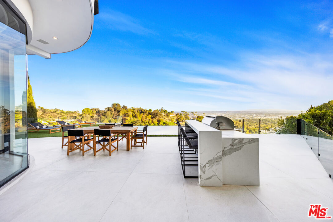 9374 Beverlycrest Drive Beverly Hills, CA 90210 - Photo 17 of 24 a view of a patio with a table and chairs