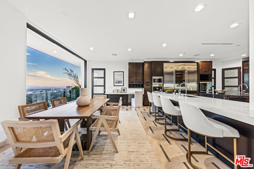 9374 Beverlycrest Drive Beverly Hills, CA 90210 - Photo 9 of 24 a view of a dining area with furniture and chandelier