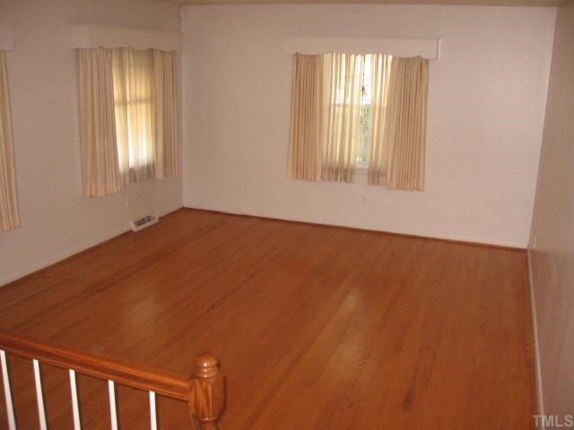 604 Peyton Street Raleigh, NC 27610 - Photo 4 of 6 Great living room with three good sized windows. Cornices cover window. Living room is step up from the downstairs family room.