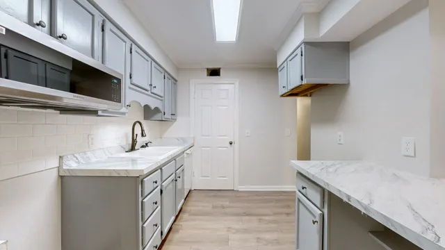 a kitchen with a sink and cabinets