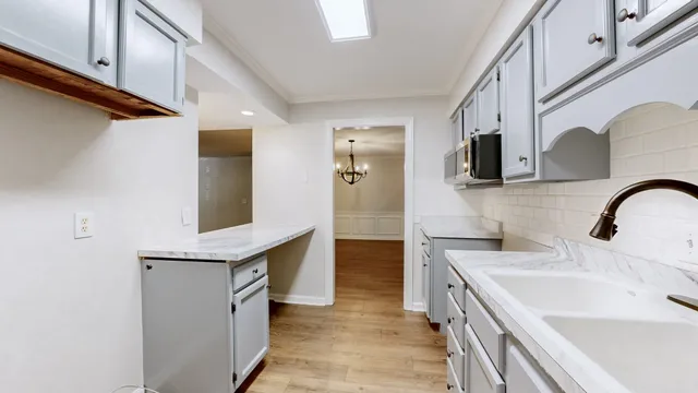 a kitchen with a sink and a refrigerator