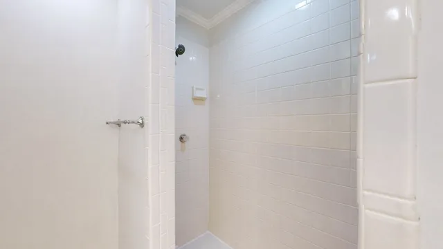 a bathroom with a tub sink vanity and mirror